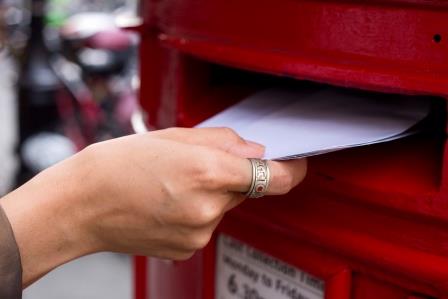 Letter being placed in a postbox