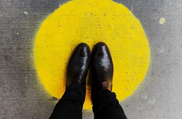 Feet standing on a yellow spot